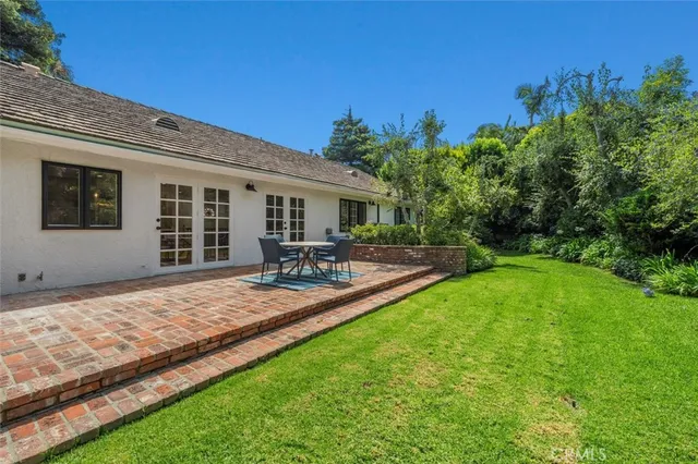 a view of a backyard with sitting area