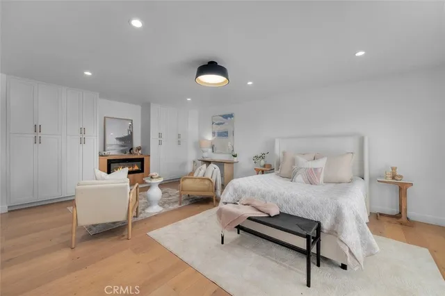 a bedroom with furniture and a wooden floor