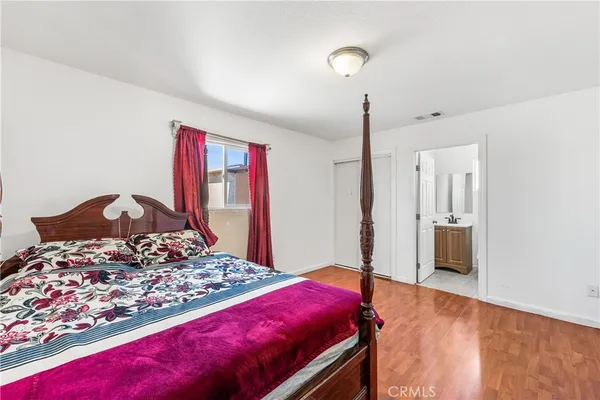 a bedroom with a large bed and a dresser