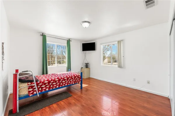 a bedroom with furniture and a window