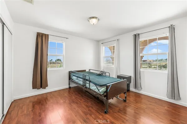 a bedroom with a bed and window