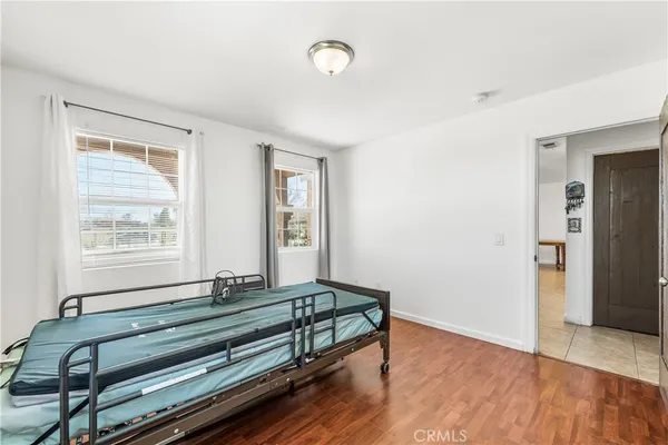a wooden bench sitting in a room next to a window