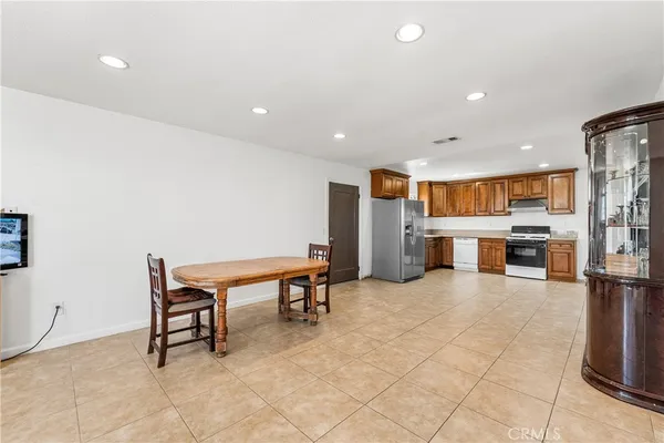 a room with stainless steel appliances kitchen island furniture and a kitchen view
