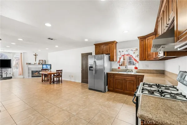 a kitchen with furniture a stove and a refrigerator