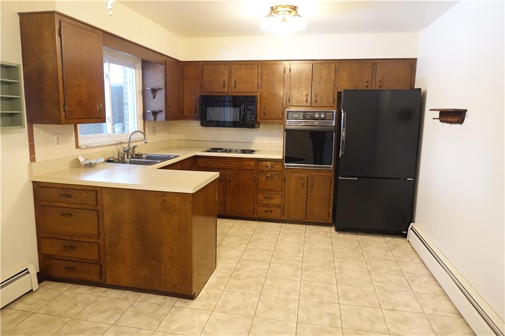 115 Randy Drive Butler, PA 16002 - Photo 5 of 25 a kitchen with granite countertop a refrigerator and a sink