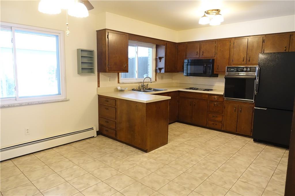 115 Randy Drive Butler, PA 16002 - Photo 7 of 25 a kitchen with stainless steel appliances granite countertop a refrigerator and a stove top oven