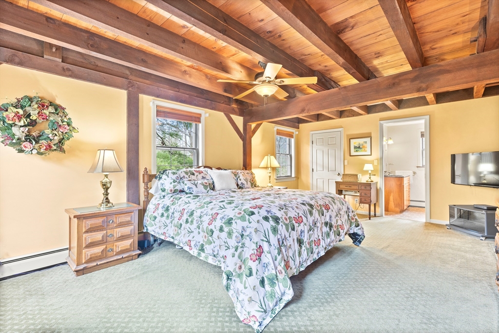 116 River Street Middleton, MA 01949 - Photo 17 of 32 a bed sitting in a spacious bedroom next to a window