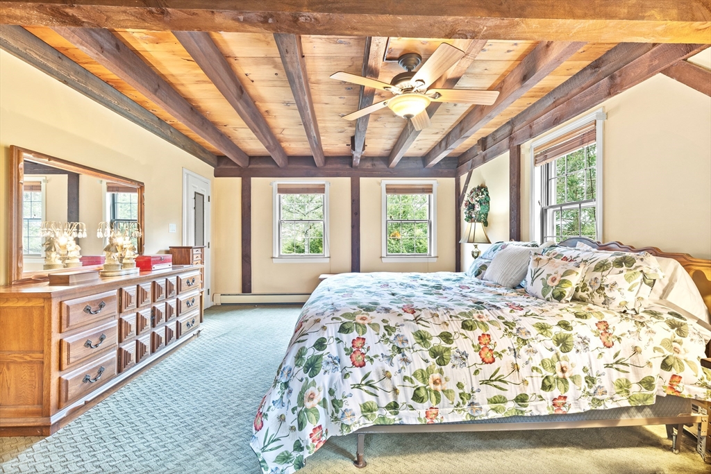 116 River Street Middleton, MA 01949 - Photo 18 of 32 a bedroom with a bed and a large window
