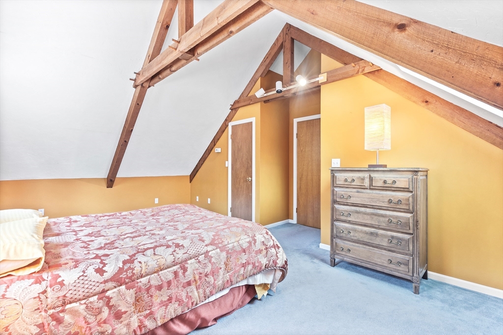 116 River Street Middleton, MA 01949 - Photo 20 of 32 a bedroom with a bed and a mirror