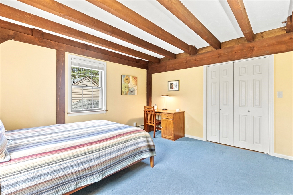 116 River Street Middleton, MA 01949 - Photo 22 of 32 a bedroom with a bed and a table