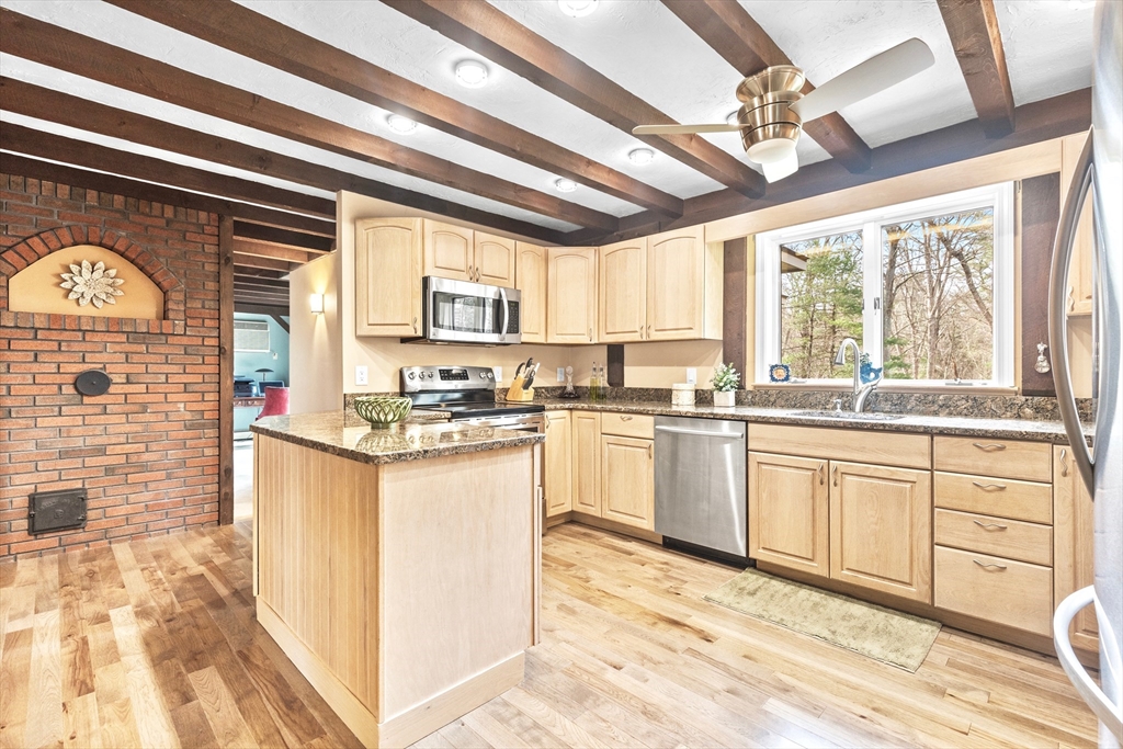 116 River Street Middleton, MA 01949 - Photo 4 of 32 a kitchen with granite countertop a sink appliances cabinets and a large window
