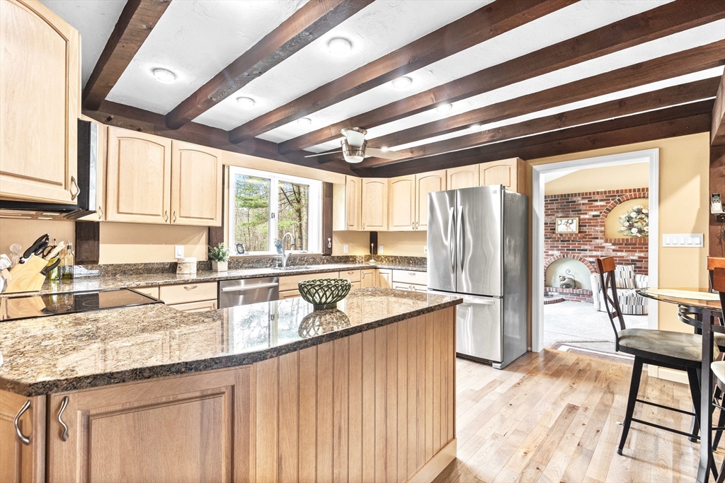 116 River Street Middleton, MA 01949 - Photo 5 of 32 a kitchen with stainless steel appliances granite countertop sink stove and large window