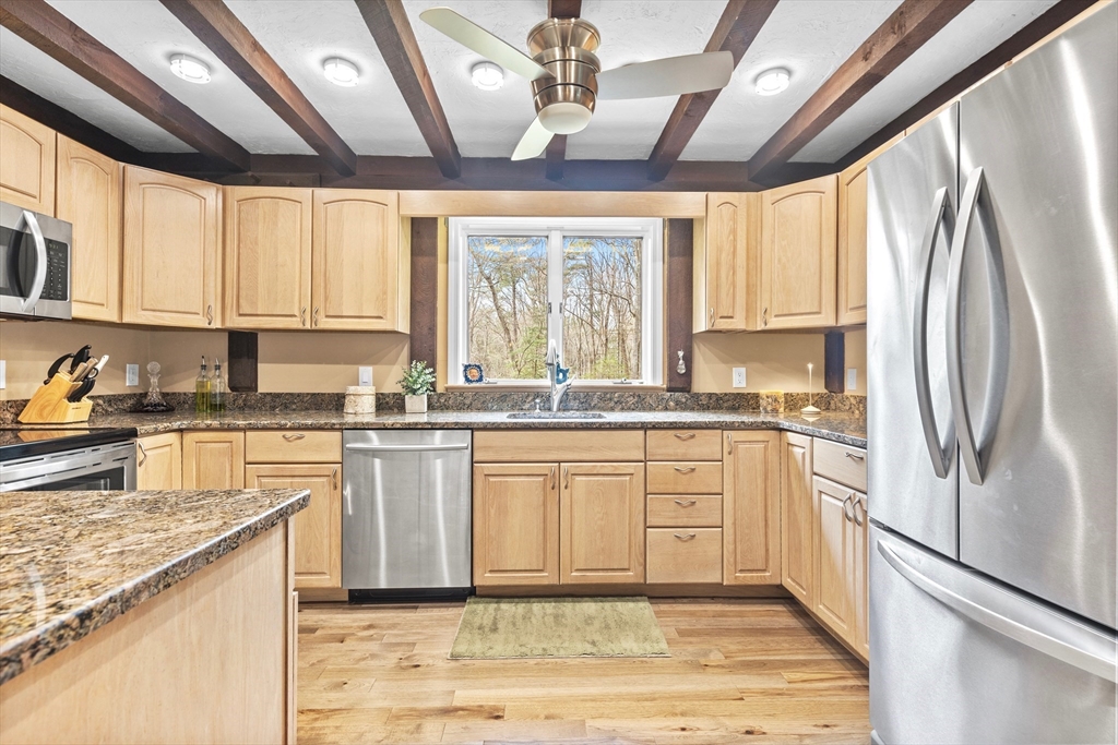 116 River Street Middleton, MA 01949 - Photo 6 of 32 a kitchen with stainless steel appliances granite countertop a refrigerator a sink dishwasher a stove and white cabinets with wooden floor