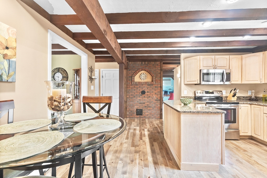 116 River Street Middleton, MA 01949 - Photo 8 of 32 a living room with granite countertop furniture and a fireplace