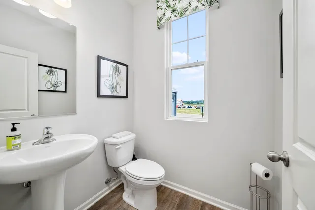 a bathroom with a sink mirror and toilet