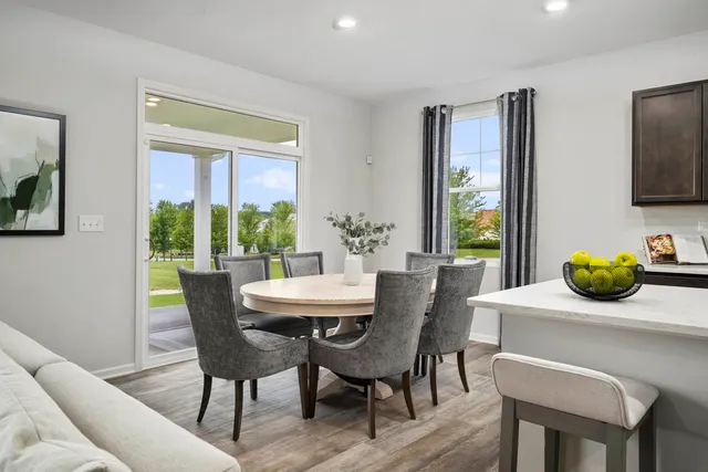 a dining room with furniture and window