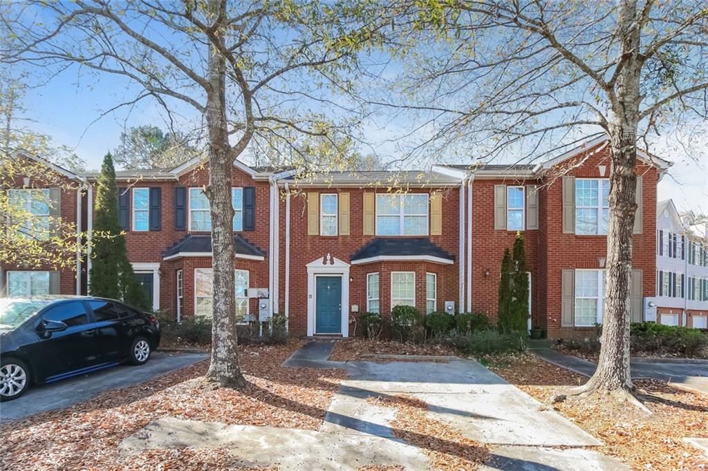 a front view of a residential apartment building with a yard