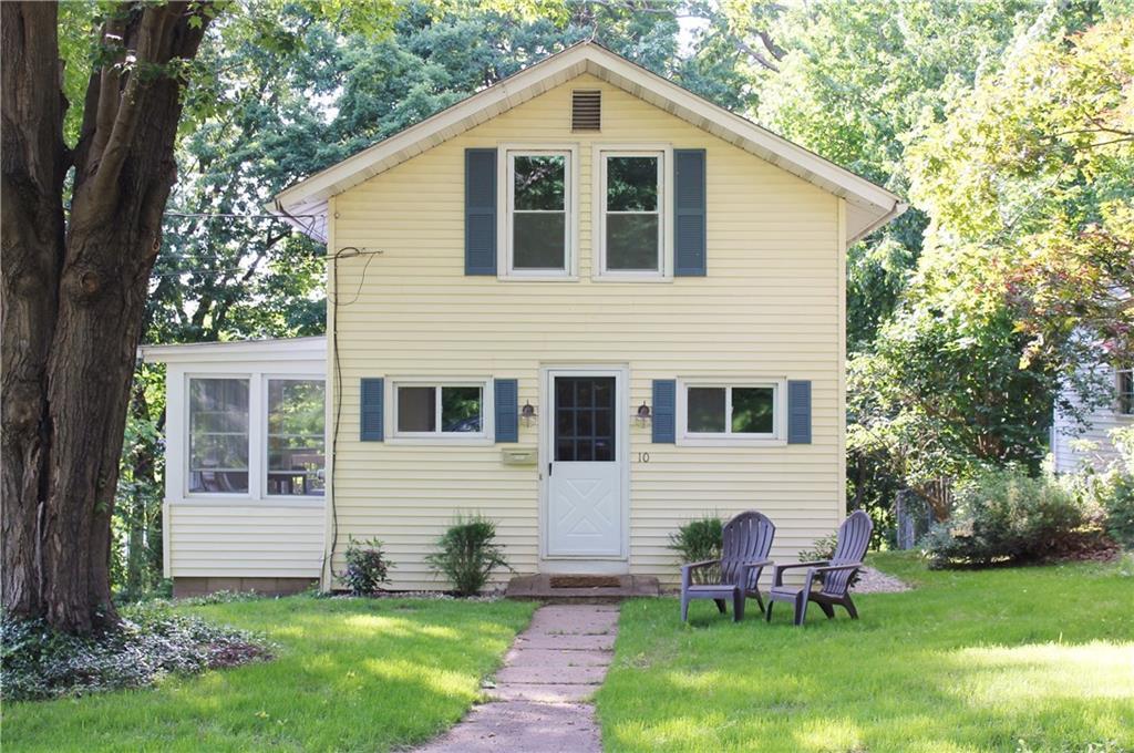 a front view of house with yard and green space