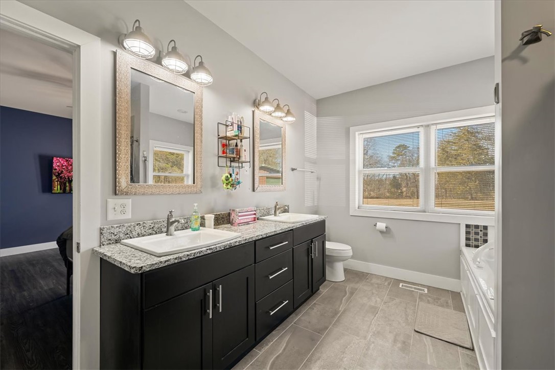 212 Winding Lane Seneca, SC 29672 - Photo 17 of 47 This bright bathroom features a spacious dual vanity, offering both style and functionality.