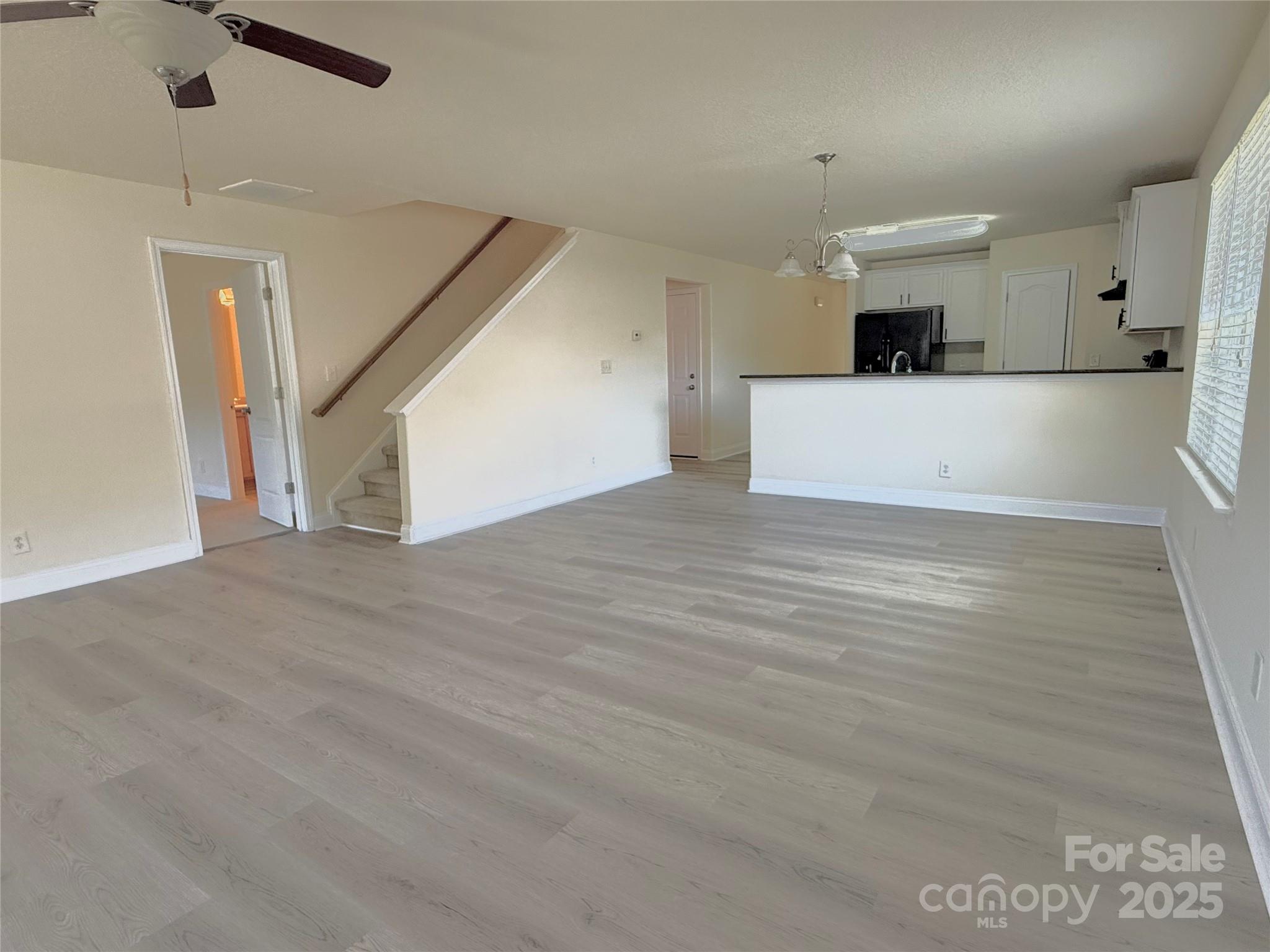 7534 April Mist Trail Huntersville, NC 28078 - Photo 11 of 47 a view of a kitchen with a sink and a refrigerator