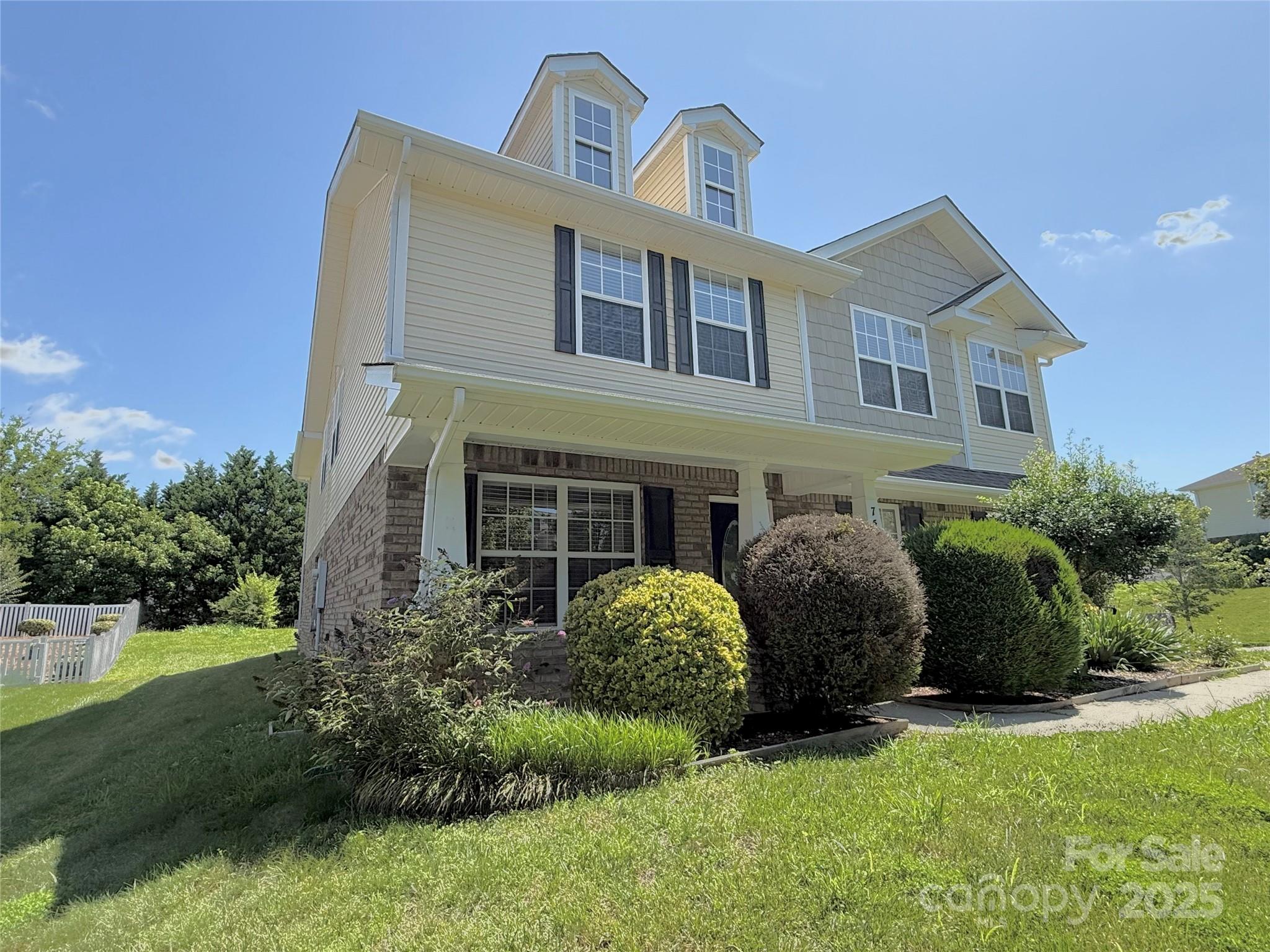 7534 April Mist Trail Huntersville, NC 28078 - Photo 2 of 47 a front view of a house with a garden