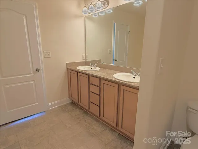 a bathroom with a sink a vanity and a mirror