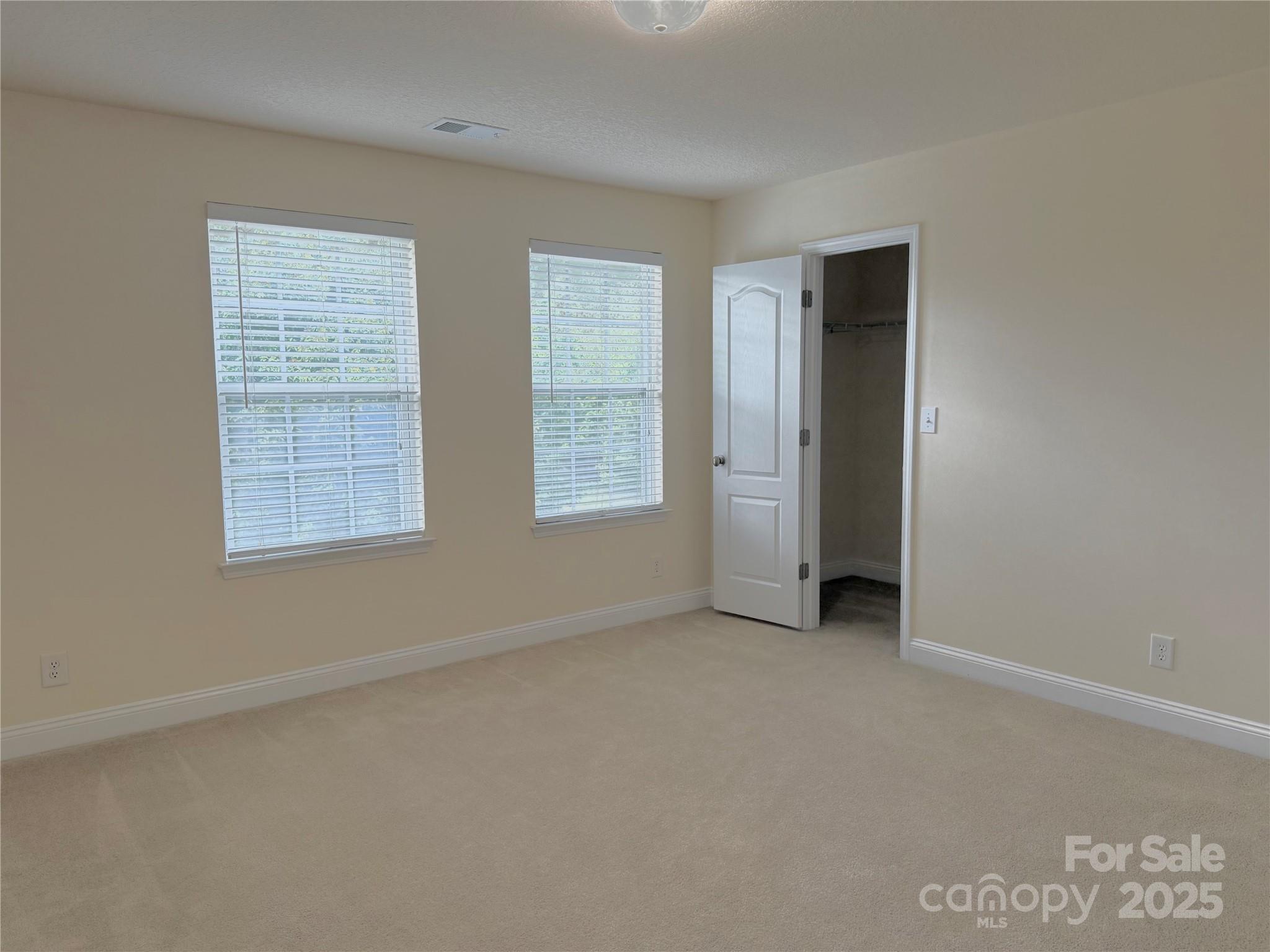 7534 April Mist Trail Huntersville, NC 28078 - Photo 25 of 47 an empty room with windows