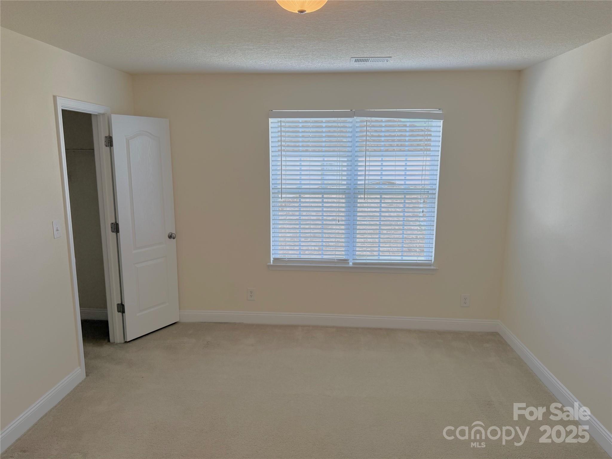 7534 April Mist Trail Huntersville, NC 28078 - Photo 27 of 47 an empty room with windows