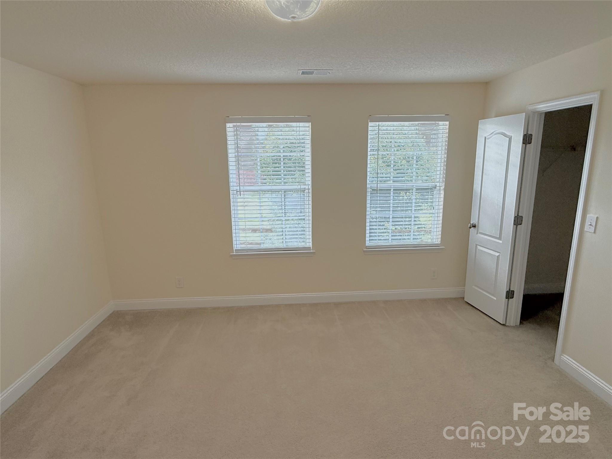 7534 April Mist Trail Huntersville, NC 28078 - Photo 28 of 47 an empty room with windows