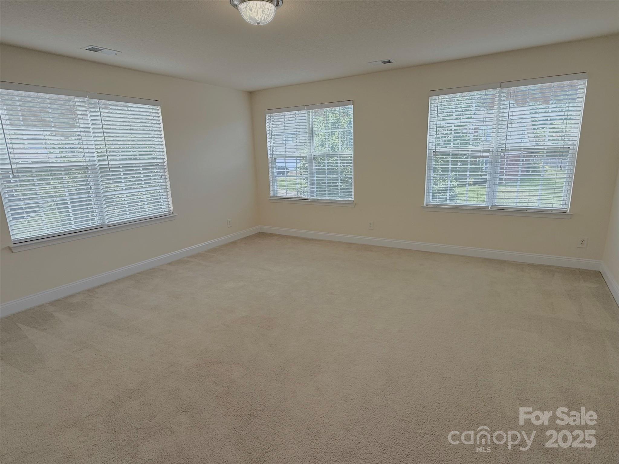 7534 April Mist Trail Huntersville, NC 28078 - Photo 29 of 47 an empty room with windows