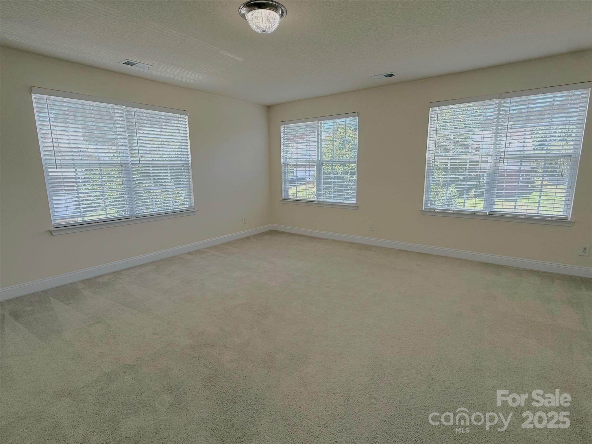 7534 April Mist Trail Huntersville, NC 28078 - Photo 32 of 47 an empty room with windows