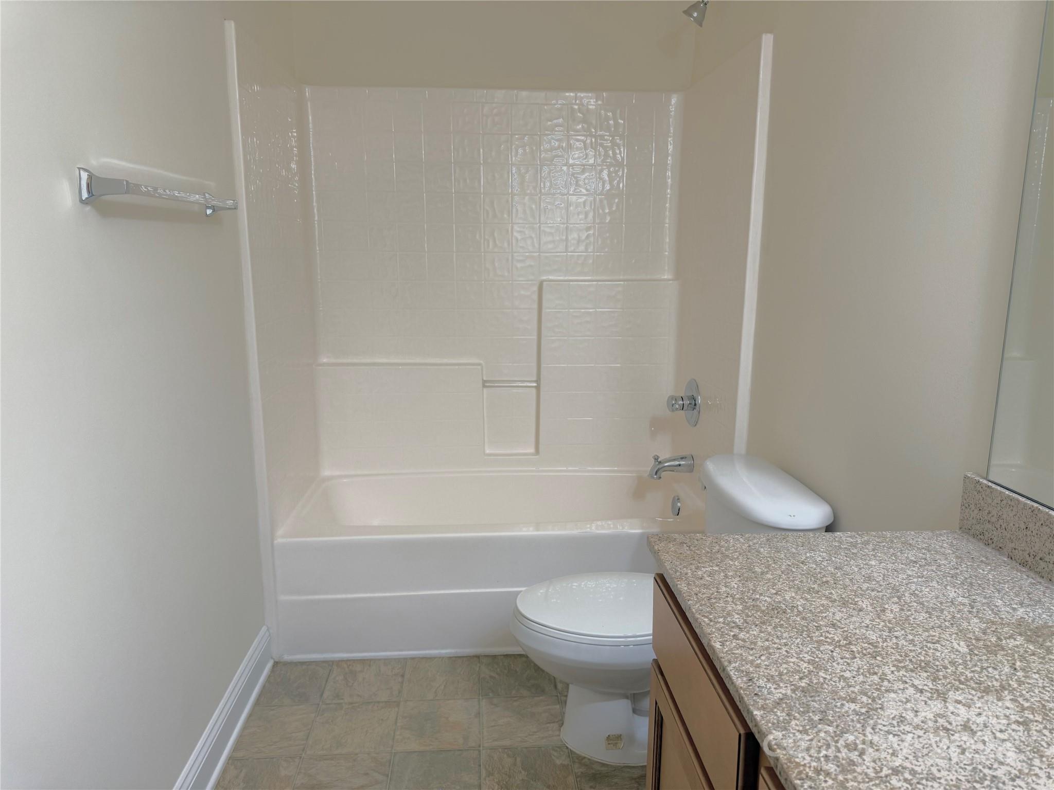 7534 April Mist Trail Huntersville, NC 28078 - Photo 37 of 47 a bathroom with a granite countertop sink toilet and shower