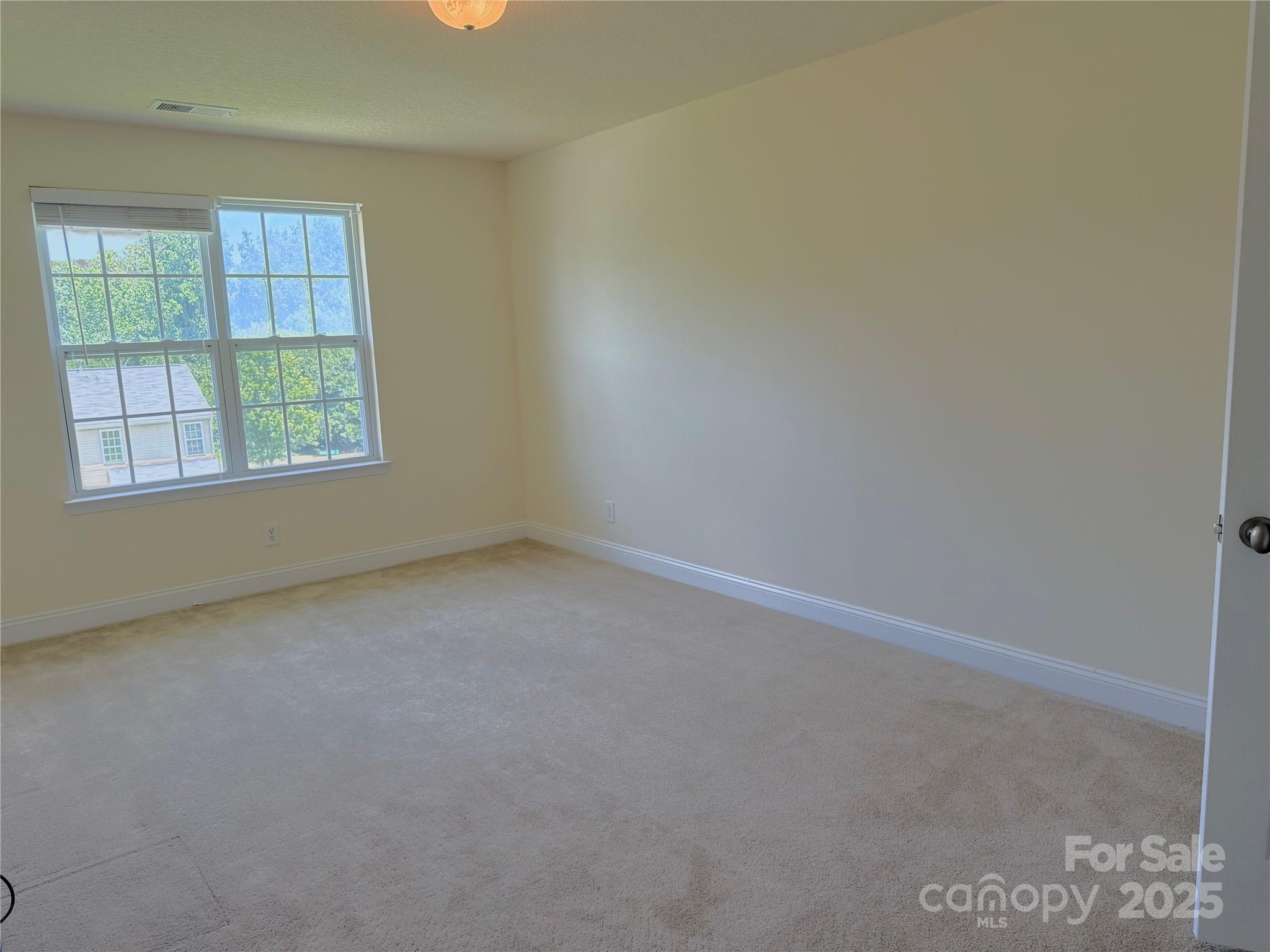 7534 April Mist Trail Huntersville, NC 28078 - Photo 39 of 47 an empty room with a window