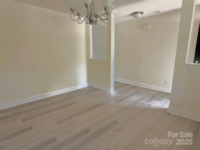 a view of a room with wooden floor