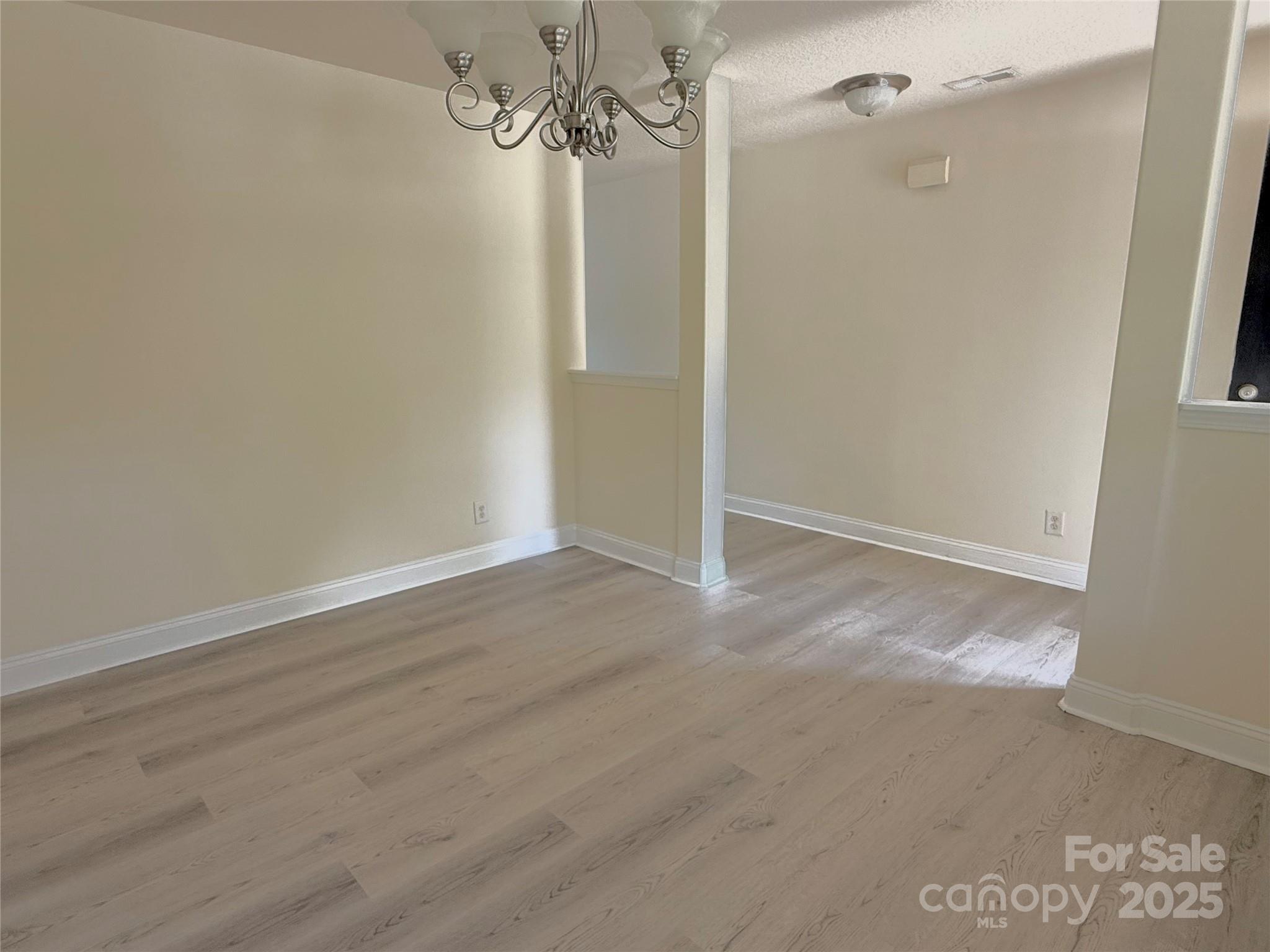 7534 April Mist Trail Huntersville, NC 28078 - Photo 4 of 47 a view of a room with wooden floor