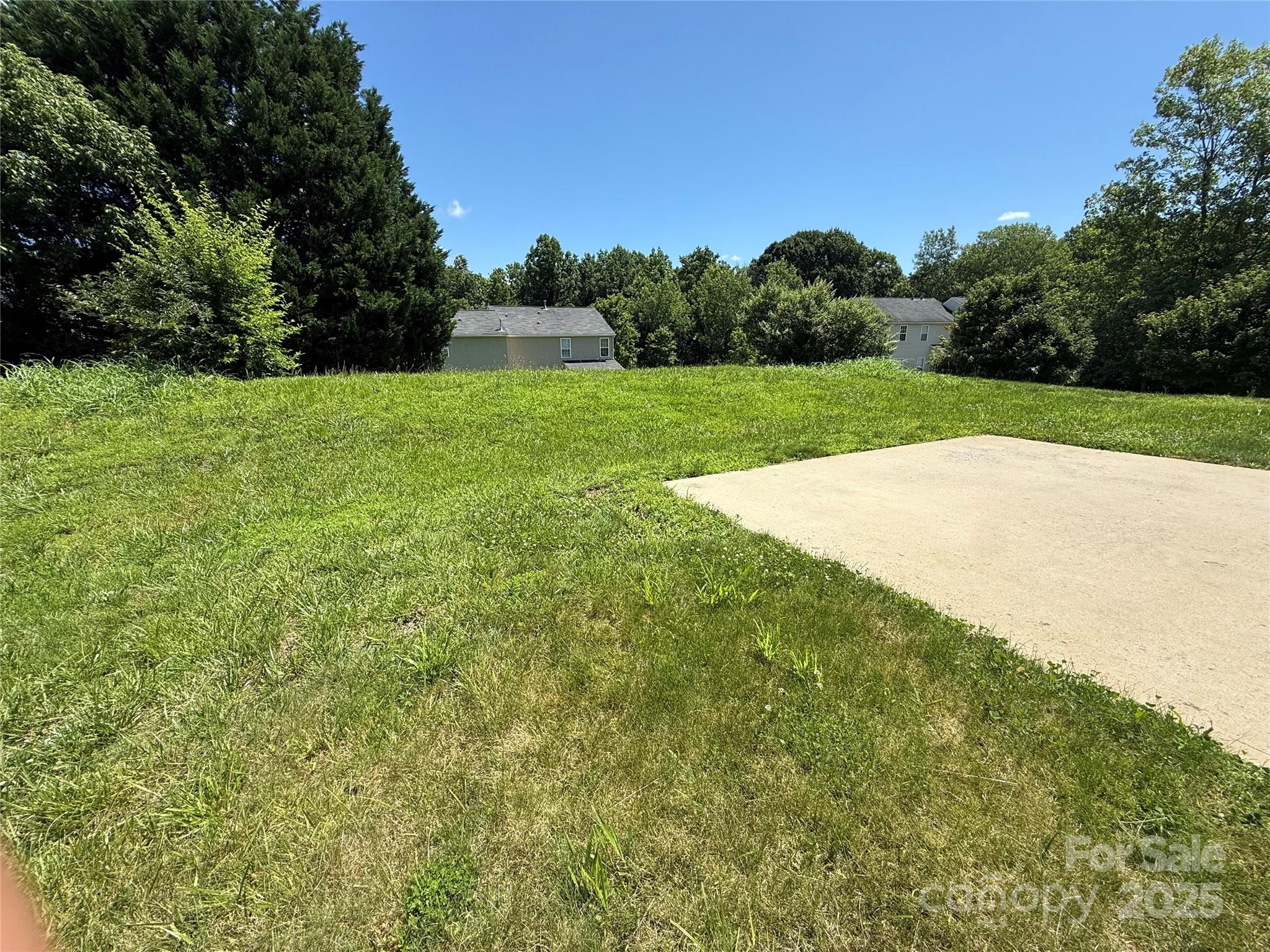 7534 April Mist Trail Huntersville, NC 28078 - Photo 47 of 47 a view of a field with trees in the background