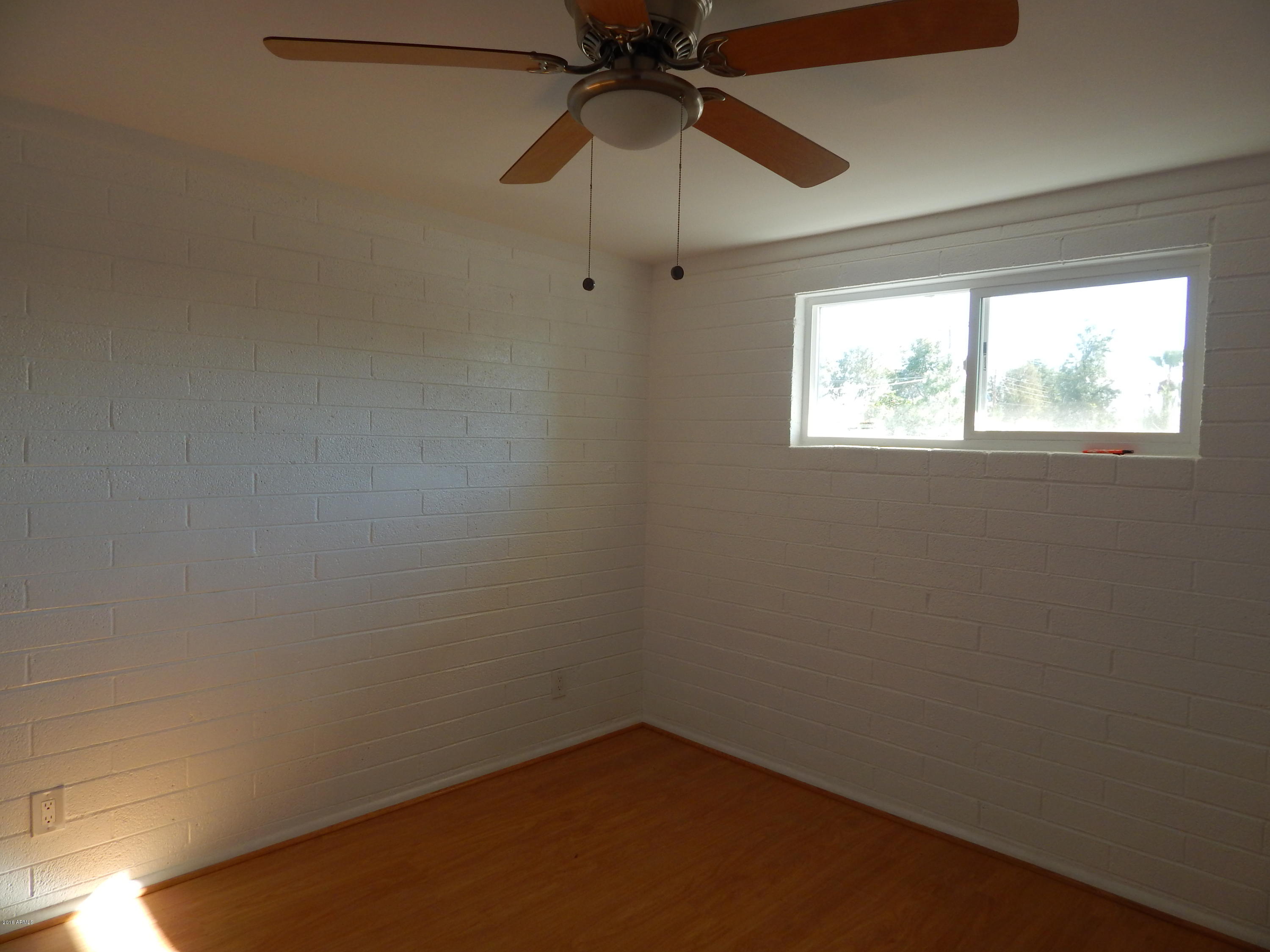 2025 South Granada Drive, Unit 12 Tempe, AZ 85282 - Photo 11 of 35 an empty room with a window