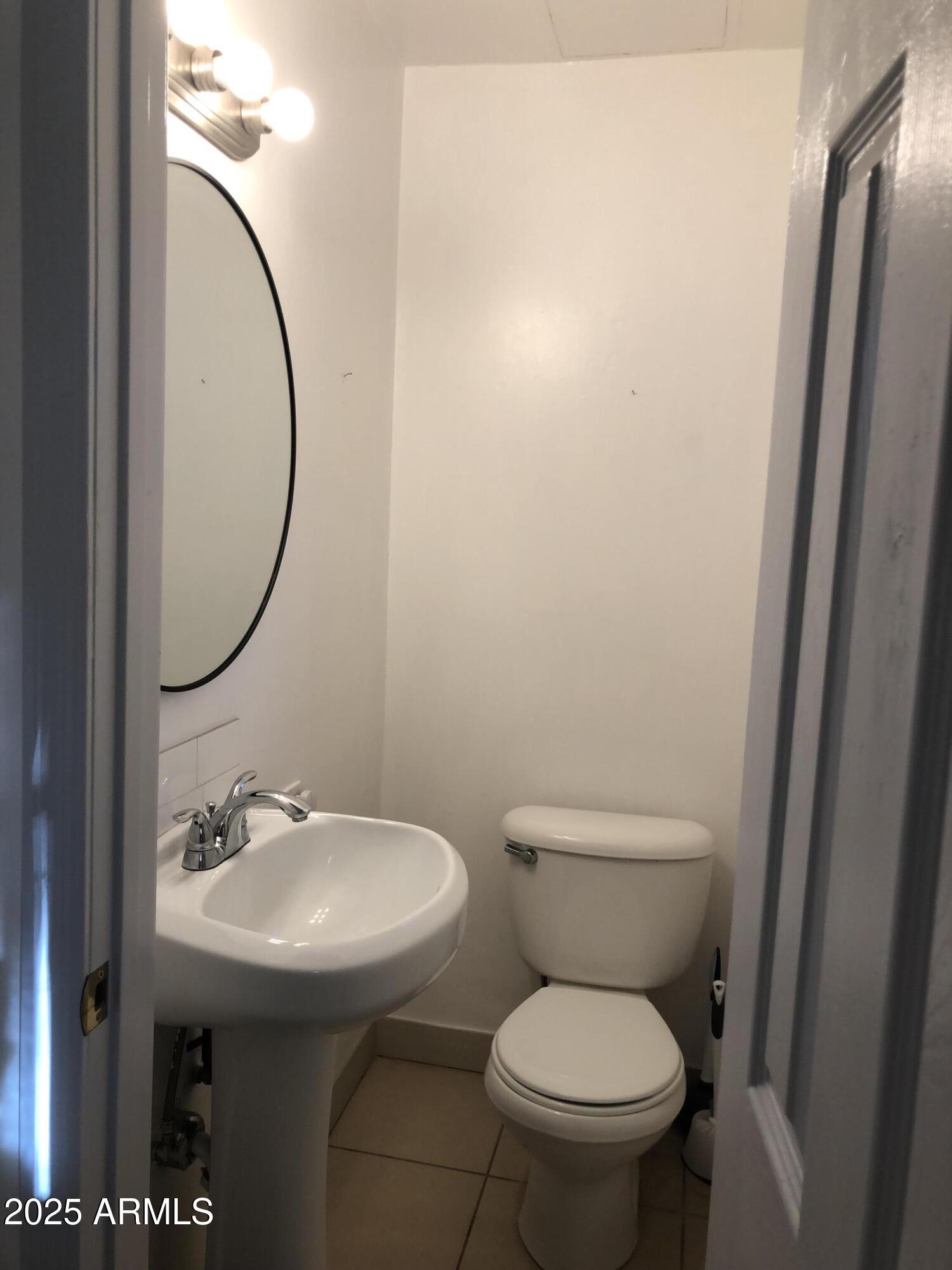 2025 South Granada Drive, Unit 12 Tempe, AZ 85282 - Photo 18 of 35 a bathroom with a toilet sink and a mirror