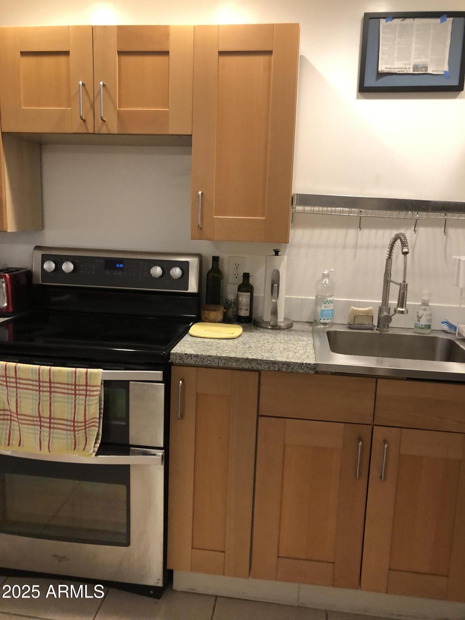 2025 South Granada Drive, Unit 12 Tempe, AZ 85282 - Photo 19 of 35 a kitchen with a sink and cabinets