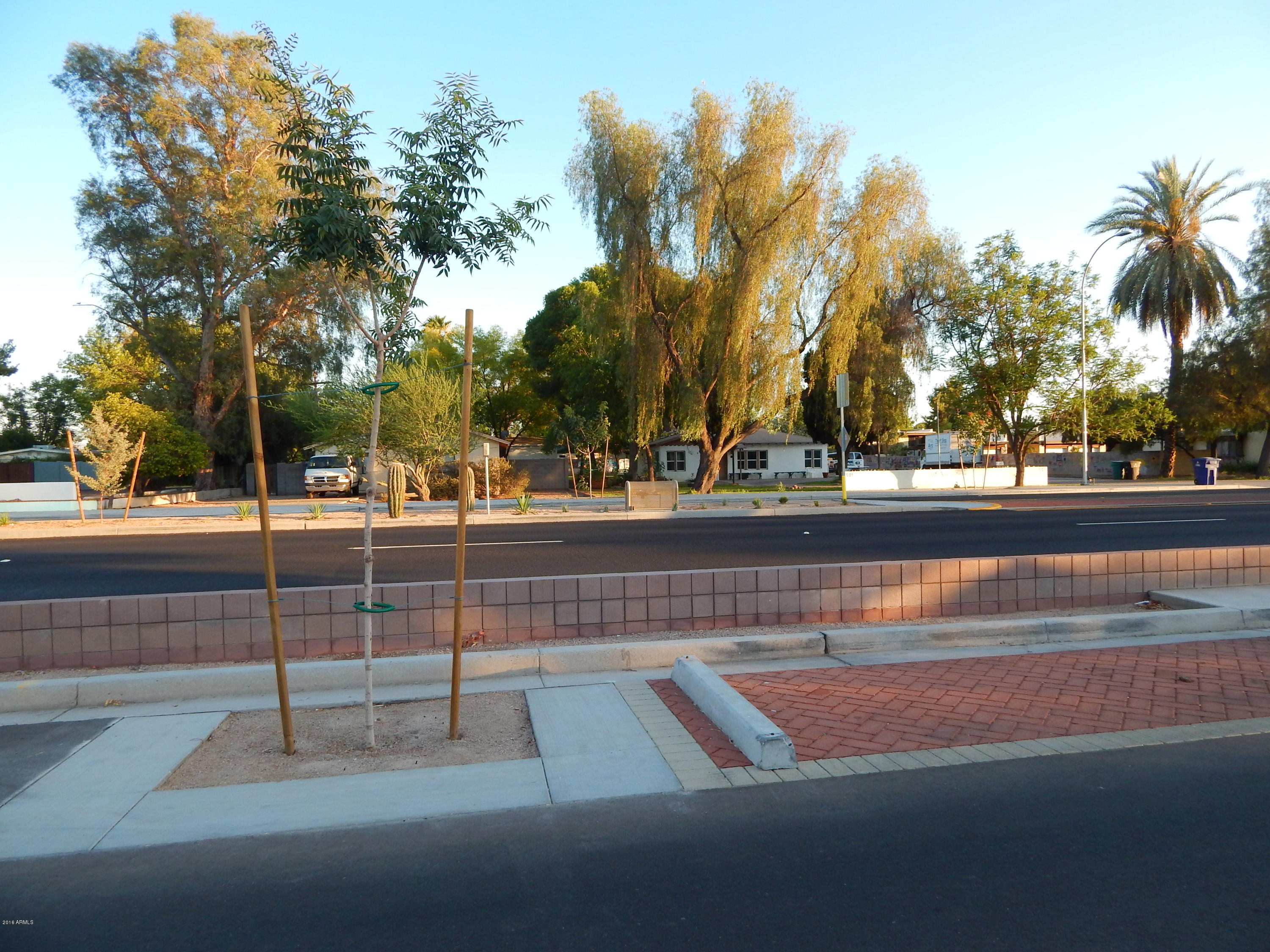 2025 South Granada Drive, Unit 12 Tempe, AZ 85282 - Photo 25 of 35 a view of swimming pool with a yard and palm trees