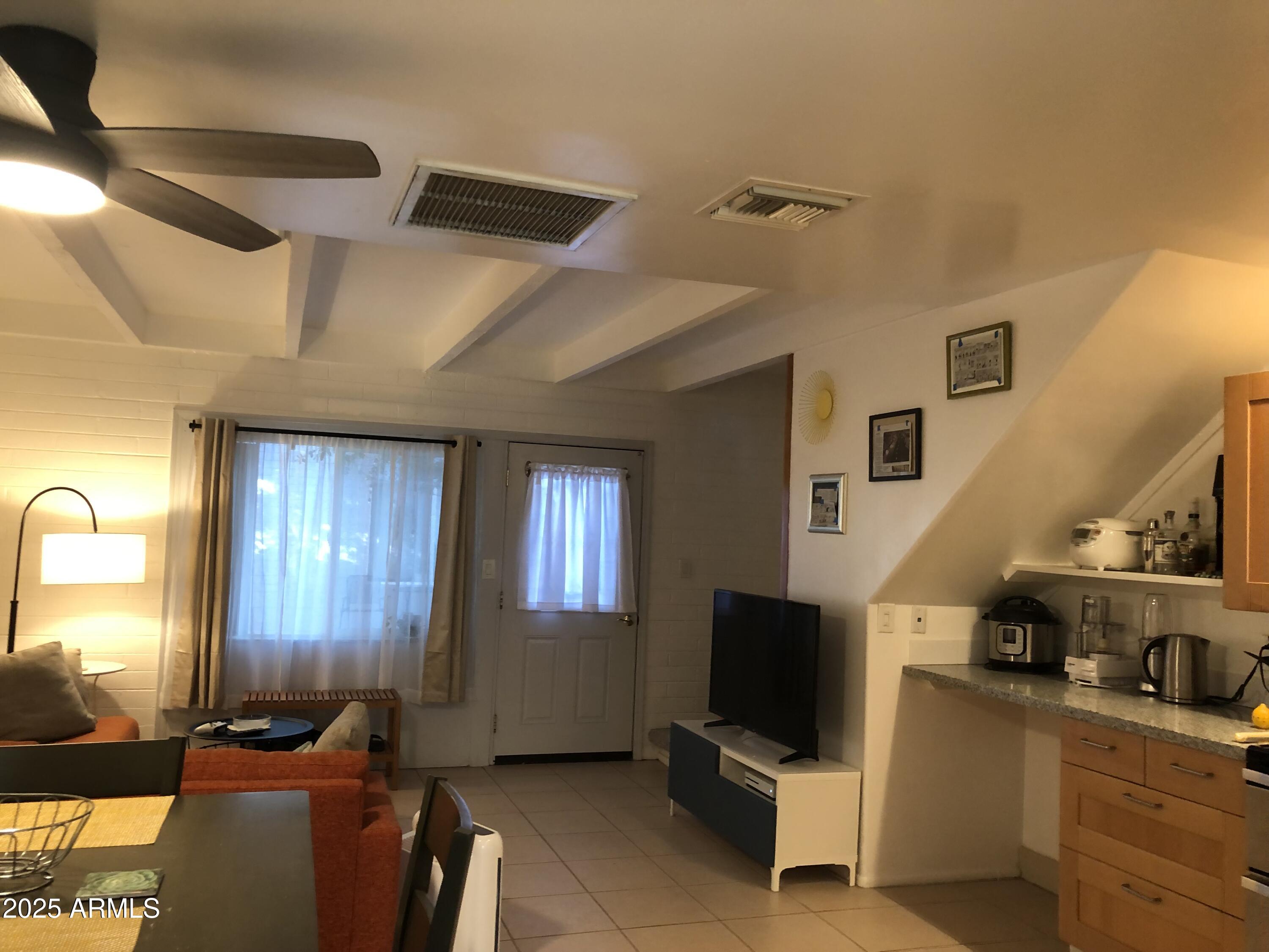 2025 South Granada Drive, Unit 12 Tempe, AZ 85282 - Photo 29 of 35 a living room with furniture and a flat screen tv