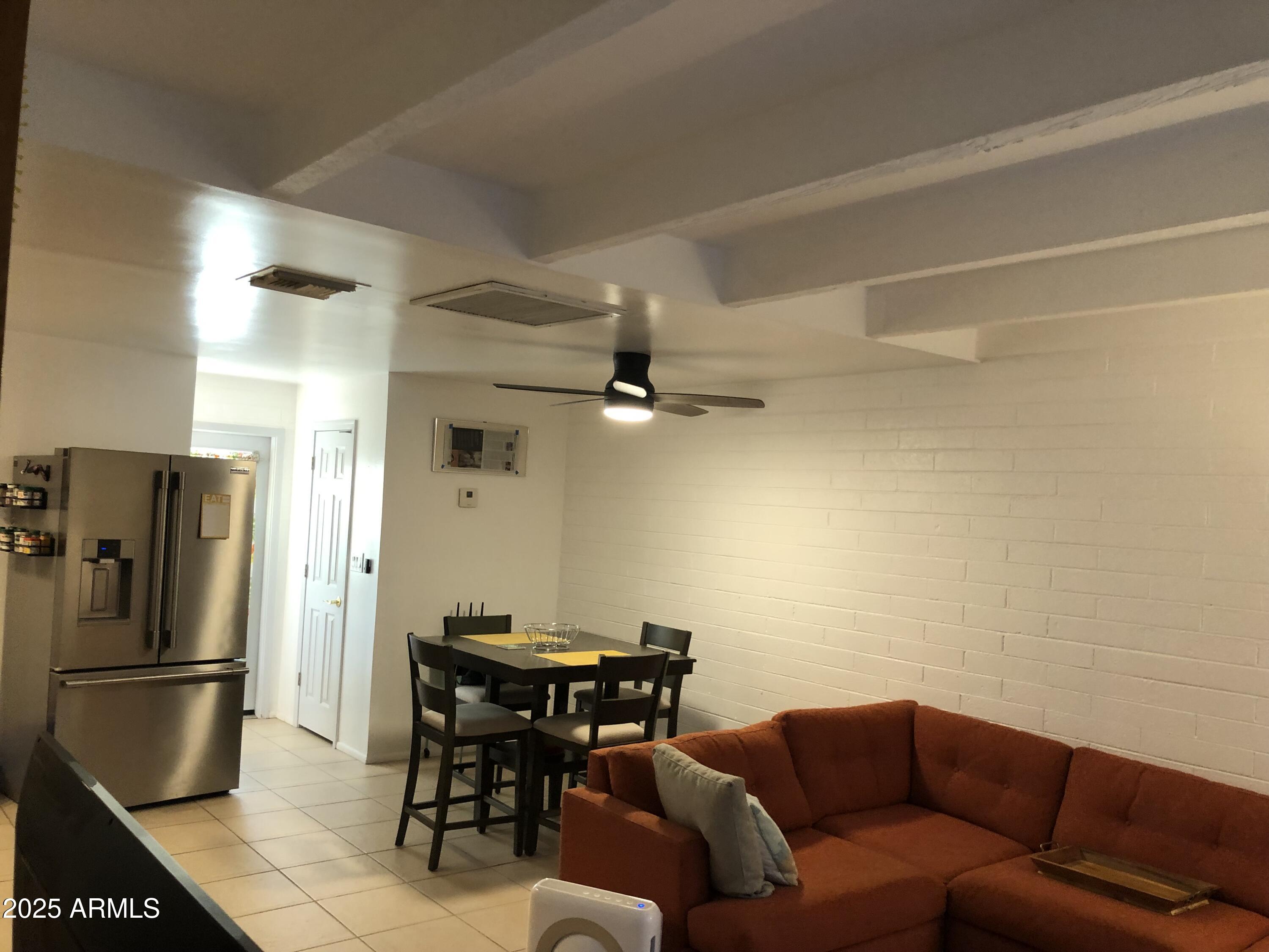 2025 South Granada Drive, Unit 12 Tempe, AZ 85282 - Photo 34 of 35 a living room with furniture a refrigerator and a table