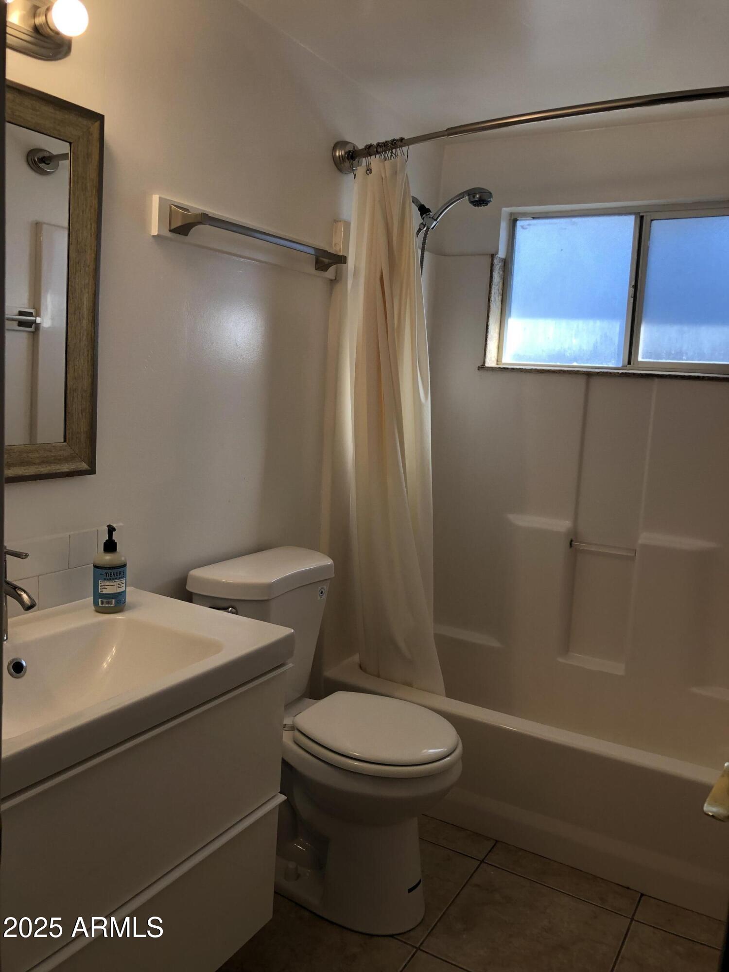 2025 South Granada Drive, Unit 12 Tempe, AZ 85282 - Photo 7 of 35 a bathroom with a toilet a sink and shower