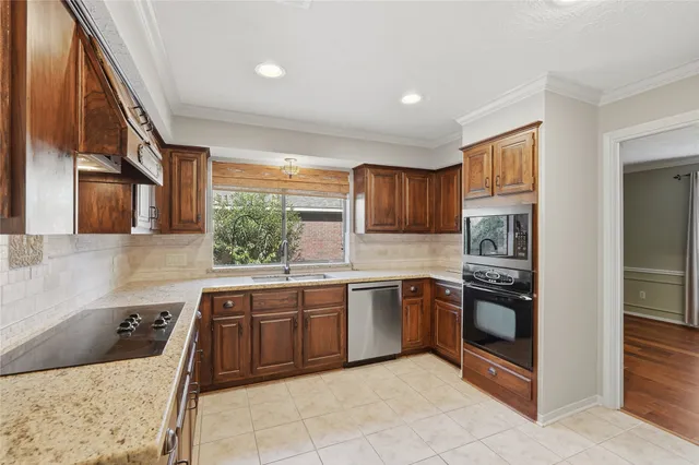 a kitchen with stainless steel appliances granite countertop a stove and a refrigerator