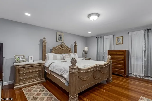 a spacious bedroom with a bed and a dresser