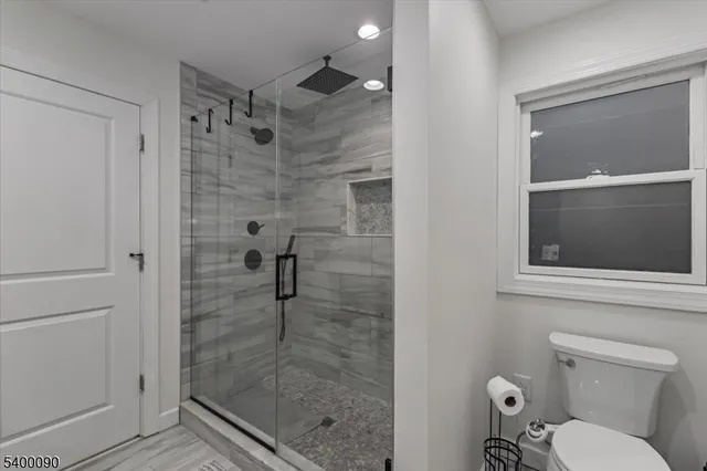 a bathroom with a shower and toilet