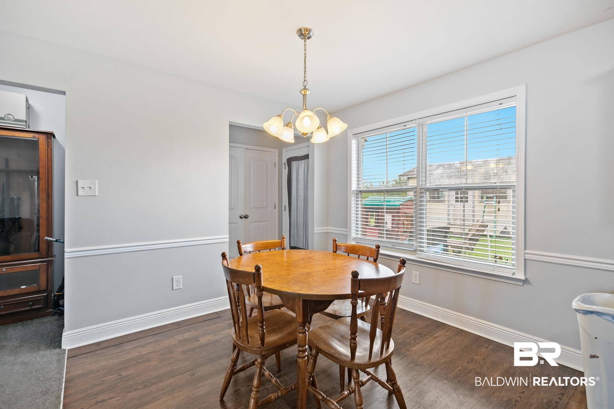 15573 Talus Court Foley, AL 36535 - Photo 19 of 50 Dining space with an inviting chandelier and dark hardwood / wood-style floors