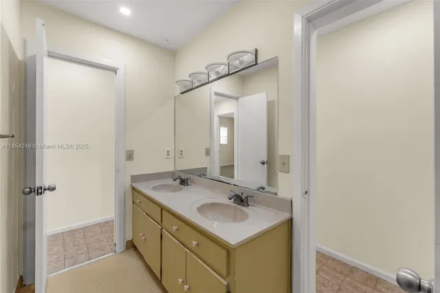 a bathroom with a sink mirror vanity and toilet