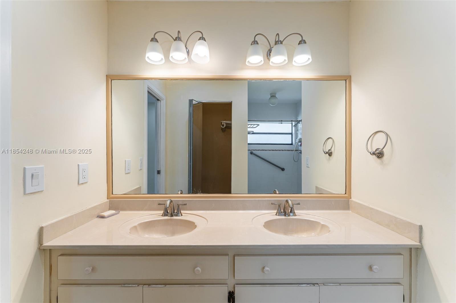9130 Southwest 101st Avenue Miami, FL 33176 - Photo 18 of 35 a bathroom with double vanity sinks and a mirror