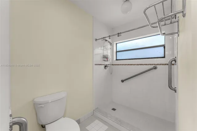 a bathroom with a toilet sink and shower
